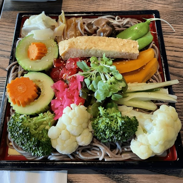 Kiku Sushi & Vegetarian's colorful bento box with soba noodles, vegetables, and tofu.